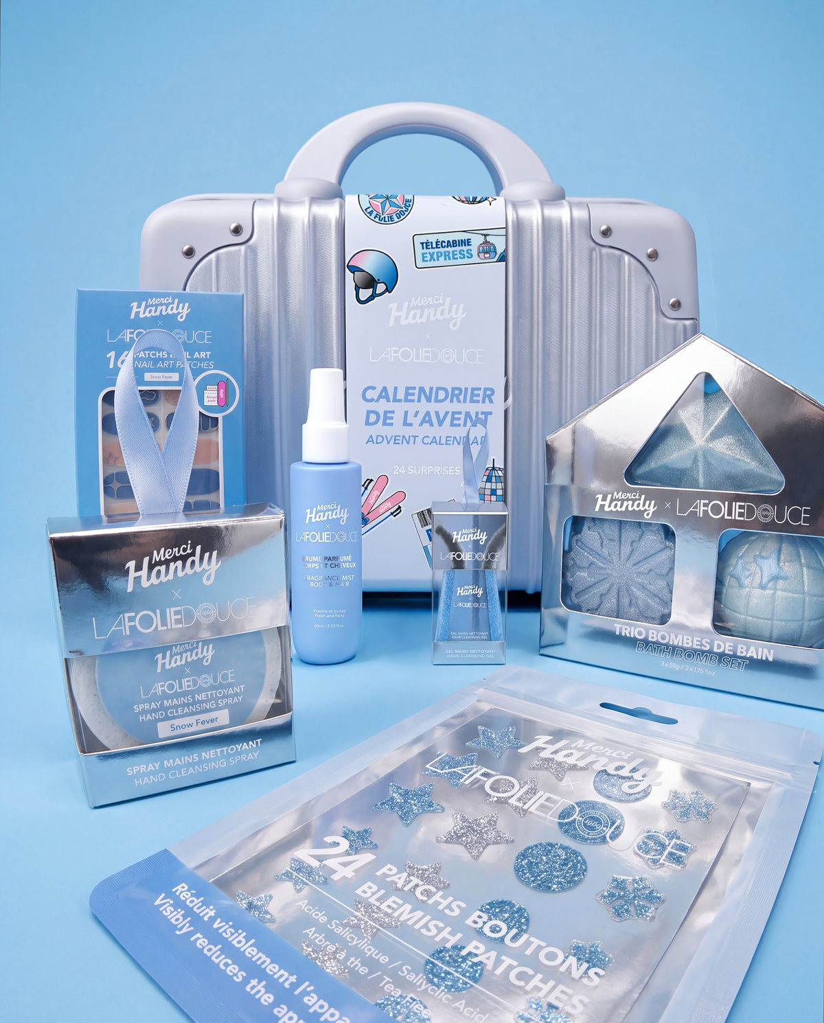Merci Handy × La Folie Douce™ edition – products of the collection in front of the Advent calendar suitcase