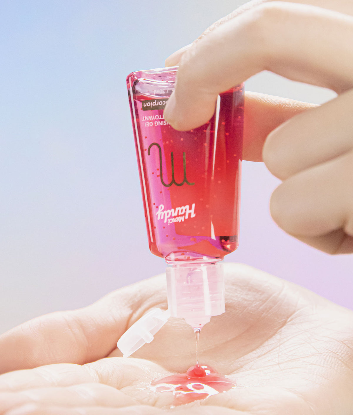 Scorpio Hand Cleansing Gel Merci Handy – bottle held above the hand